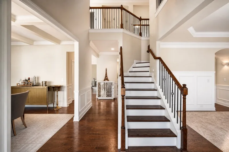 Two-story foyer with wood staircase