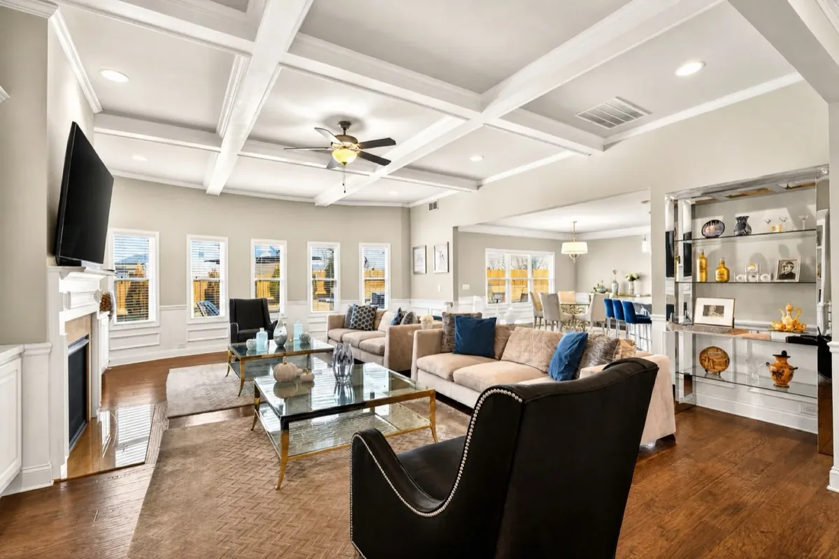 Living room with a coffered ceiling and tall windows in a Greer home Geoff sold