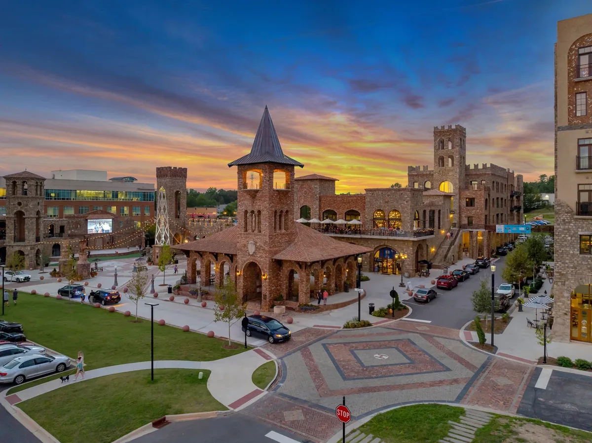 Sunset over the BridgeWay Station plaza in Mauldin, with the brick pavilion and storefront lights